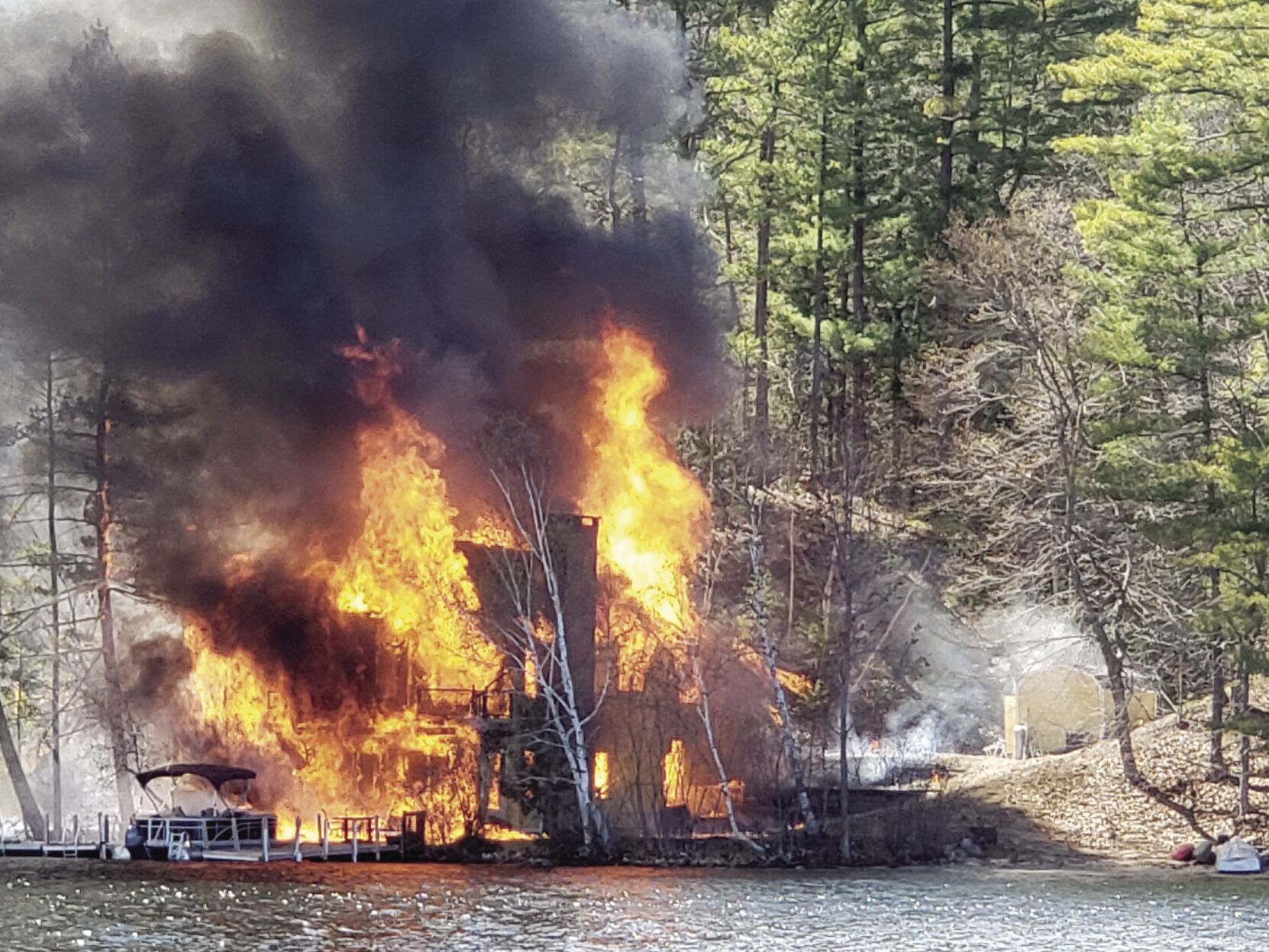 Fire rips through waterfront home